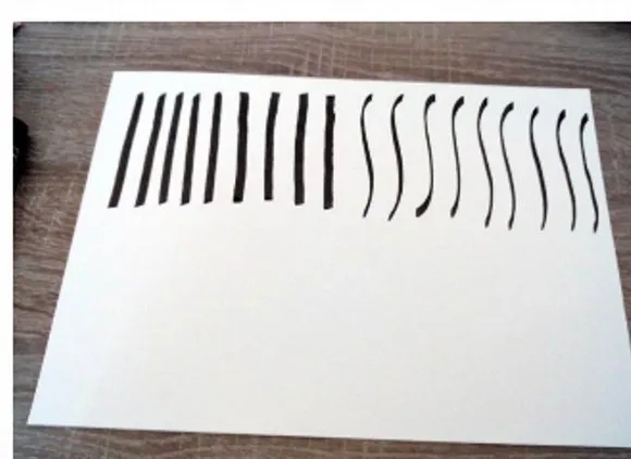 Une ligne de Alif calligraphiés, droits puis ondulés